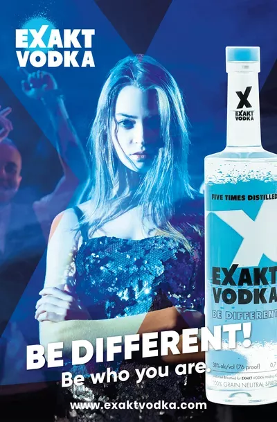 Eine Frau steht neben einer Flasche Wodka.